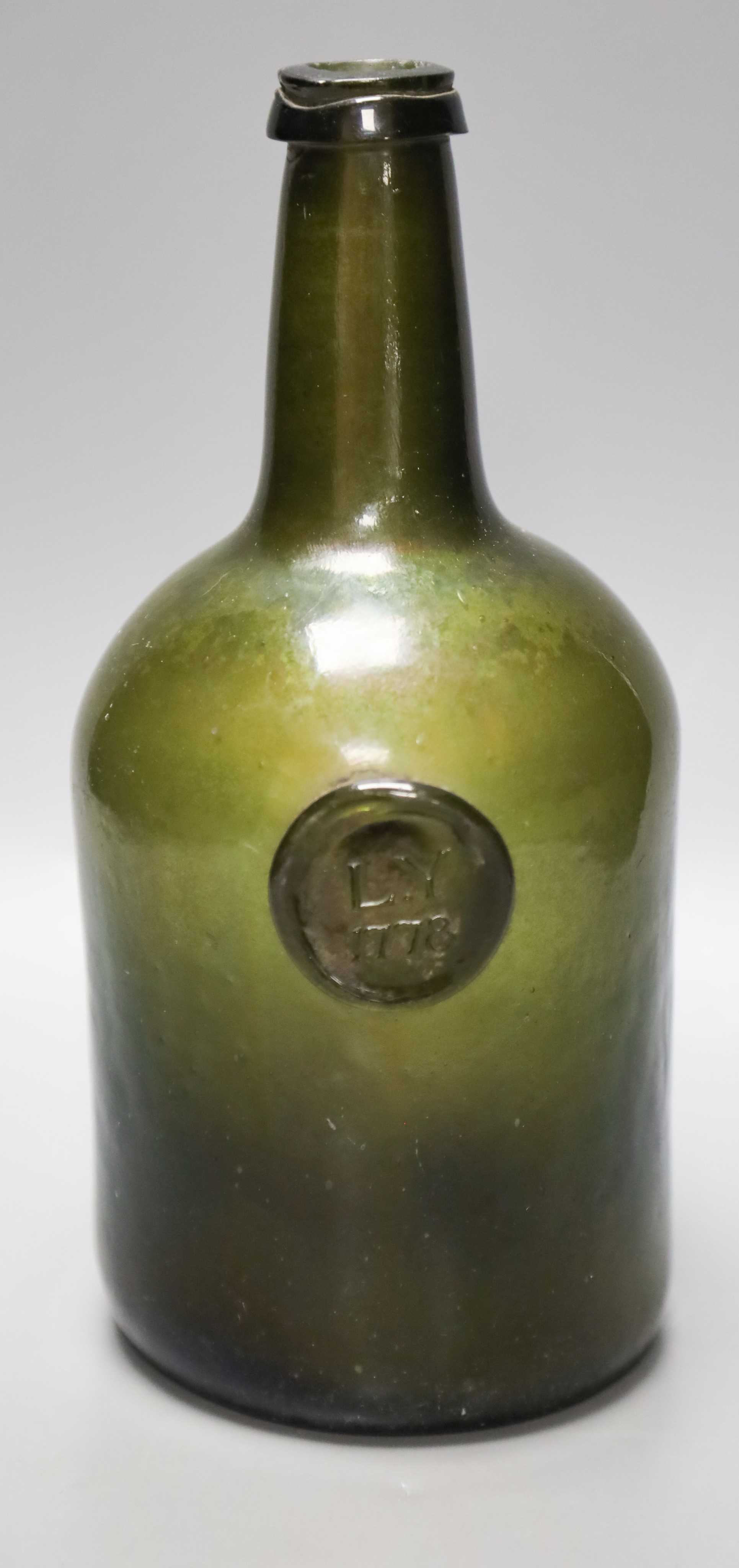 A George III green glass sealed wine bottle, dated 1778 26cm